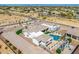 This aerial view showcases a property with a pool, RV, and other amenities in a desert setting at 447 W Judd Rd, San Tan Valley, AZ 85143