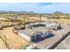 This aerial shows the guest house, barn and garages on a desert property that includes an RV at 447 W Judd Rd, San Tan Valley, AZ 85143