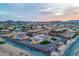 Dusk aerial showcases custom home with lush landscaping, sparkling pool, and mountain views at 447 W Judd Rd, San Tan Valley, AZ 85143