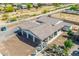 Aerial view of a covered patio area with outdoor seating next to a waterfall feature and sparkling pool at 447 W Judd Rd, San Tan Valley, AZ 85143