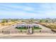 Stunning aerial view of estate featuring a circular driveway, well-manicured lawns, and mountain views at 447 W Judd Rd, San Tan Valley, AZ 85143