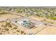Aerial view featuring a custom home, sparkling pool, horse facilities and desert landscaping at 447 W Judd Rd, San Tan Valley, AZ 85143