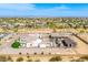 View of a large estate featuring a custom home, barn, pool and playground set against desert landscape at 447 W Judd Rd, San Tan Valley, AZ 85143