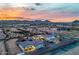 Expansive desert home showcasing the backyard pool, RV parking, and stunning mountain views during sunset at 447 W Judd Rd, San Tan Valley, AZ 85143