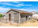 Rustic gray barn with white trim and gated paddock, perfect for horses or other animals at 447 W Judd Rd, San Tan Valley, AZ 85143