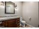 Bathroom features modern lighting, a marble countertop, and sleek, dark-wood cabinetry at 447 W Judd Rd, San Tan Valley, AZ 85143
