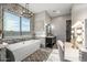 Bright bathroom featuring a soaking tub, vanity, and makeup area with great natural light and stylish decor at 447 W Judd Rd, San Tan Valley, AZ 85143