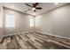 Spacious bedroom with wood-look flooring, modern ceiling fan, and neutral paint at 447 W Judd Rd, San Tan Valley, AZ 85143