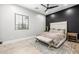 Modern bedroom features a large window, neutral decor, and a comfortable bed with stylish accents at 447 W Judd Rd, San Tan Valley, AZ 85143