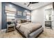 Comfortable bedroom featuring a queen bed, stylish decor, and access to an ensuite bathroom at 447 W Judd Rd, San Tan Valley, AZ 85143