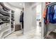 Custom walk-in closet offering substantial storage capacity with built-in shelving and hanging areas at 447 W Judd Rd, San Tan Valley, AZ 85143