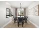 Elegant dining room featuring a large table, stylish chairs, modern chandelier, and lots of light at 447 W Judd Rd, San Tan Valley, AZ 85143