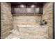Tiled dog wash station with granite countertop and upper cabinets for a convenient pet-friendly feature at 447 W Judd Rd, San Tan Valley, AZ 85143