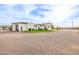 Custom home with professionally landscaped yard, garage, turf, and circular driveway at 447 W Judd Rd, San Tan Valley, AZ 85143