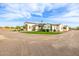 Beautiful custom home with a circular driveway, professionally landscaped yard, and turf at 447 W Judd Rd, San Tan Valley, AZ 85143