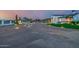 An inviting, custom home with a circular driveway and beautifully lit landscaping at dusk at 447 W Judd Rd, San Tan Valley, AZ 85143