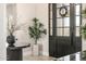 Close-up view of the foyer showcasing a modern table, plants, and decorative front door at 447 W Judd Rd, San Tan Valley, AZ 85143