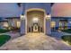 Charming front entrance with travertine walkway, seating, and striking arched entry at 447 W Judd Rd, San Tan Valley, AZ 85143