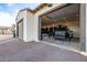Spacious four car garage featuring a black Ford and Jeep with overhead lighting, and ample storage space at 447 W Judd Rd, San Tan Valley, AZ 85143