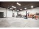 Spacious garage with high ceilings, lift, overhead lighting, and ample workspace for car enthusiasts at 447 W Judd Rd, San Tan Valley, AZ 85143