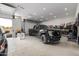 Bright and spacious garage featuring a black Ford F-250, overhead lighting, and ample storage space at 447 W Judd Rd, San Tan Valley, AZ 85143
