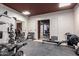 Home gym with weights, mirrors, and access to the garage at 447 W Judd Rd, San Tan Valley, AZ 85143