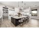 Gourmet kitchen with a large island, modern appliances, stylish pendant lights and hardwood floors at 447 W Judd Rd, San Tan Valley, AZ 85143