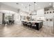 Bright, spacious kitchen with a large island, pendant lights, and modern white cabinetry next to the dining room at 447 W Judd Rd, San Tan Valley, AZ 85143