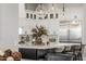 Close up of a kitchen island with pendant lighting, seating, and marble countertops with stainless appliances at 447 W Judd Rd, San Tan Valley, AZ 85143