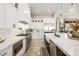 A kitchen with stainless steel appliances, white cabinets, marble countertops, and a farmhouse sink at 447 W Judd Rd, San Tan Valley, AZ 85143
