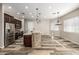 Open-concept kitchen with stainless steel appliances, a large island, and a breakfast bar for casual dining at 447 W Judd Rd, San Tan Valley, AZ 85143