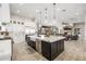An open-concept kitchen with a large island, marble countertops, stainless steel appliances, and pendant lights at 447 W Judd Rd, San Tan Valley, AZ 85143