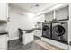 Well-equipped laundry room featuring modern appliances, ample storage, and a convenient countertop workspace at 447 W Judd Rd, San Tan Valley, AZ 85143