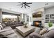 Comfortable living room featuring a stone fireplace, plush seating, and access to the pool area at 447 W Judd Rd, San Tan Valley, AZ 85143