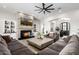 Spacious living room with stone fireplace, large sectional sofa, and an open floor plan at 447 W Judd Rd, San Tan Valley, AZ 85143