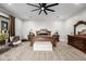 The expansive main bedroom is adorned with a ceiling fan, neutral colors, and stylish wooden furniture at 447 W Judd Rd, San Tan Valley, AZ 85143