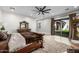 Main bedroom with an outdoor view, adorned with a decorative rug, wooden furniture, and a ceiling fan at 447 W Judd Rd, San Tan Valley, AZ 85143