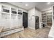 Mudroom with a built-in bench, hooks, baskets, stainless mini fridge, and a view of the pantry at 447 W Judd Rd, San Tan Valley, AZ 85143