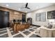 Office with wood-paneled accent wall, ceiling fan, and a custom-built desk on black and wood floors at 447 W Judd Rd, San Tan Valley, AZ 85143