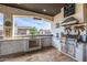 Outdoor kitchen with stainless steel grill, sink, bar and unique decorations for a tropical paradise at 447 W Judd Rd, San Tan Valley, AZ 85143