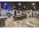 A covered patio is perfect for outdoor entertaining with its built-in bar, outdoor kitchen and dining area at 447 W Judd Rd, San Tan Valley, AZ 85143