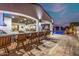 An outdoor kitchen and bar area create the perfect flow from indoor to outdoor living and entertaining at 447 W Judd Rd, San Tan Valley, AZ 85143