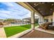 Stylish patio with comfortable seating, a view of the pool, and well-manicured lawn for outdoor relaxation at 447 W Judd Rd, San Tan Valley, AZ 85143
