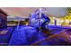 Backyard playground illuminated in blue lighting, featuring a play structure with a slide at 447 W Judd Rd, San Tan Valley, AZ 85143