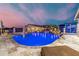 Inviting pool with rock waterfall feature and sun loungers, perfect for relaxation and outdoor entertainment at 447 W Judd Rd, San Tan Valley, AZ 85143