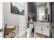 Stylish powder room features a modern vanity, decorative wall, and a convenient toilet paper basket at 447 W Judd Rd, San Tan Valley, AZ 85143