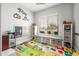 Bright room with alphabet rug, play area, storage, and a comfortable window seat at 447 W Judd Rd, San Tan Valley, AZ 85143