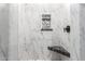 Modern shower with white marble-style tiles, a built-in niche, and bench seating at 447 W Judd Rd, San Tan Valley, AZ 85143