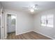 Bright bedroom featuring a ceiling fan, wood floors, and a window with natural light at 4502 E Carol Ave # 1, Mesa, AZ 85206