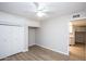 Spacious bedroom with wood floors, ceiling fan, closet, and hall access to the kitchen at 4502 E Carol Ave # 1, Mesa, AZ 85206